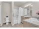 Well-lit bathroom features double sinks, ample counter space, and a shower-tub combo at 700 Daniel Ellis Dr # 3108, Charleston, SC 29412