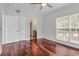 Bright bedroom features gleaming wood floors, natural light from a window, and ensuite bathroom entrance at 700 Daniel Ellis Dr # 3108, Charleston, SC 29412