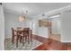 Bright dining area features hardwood floors, modern lighting fixture and view of the kitchen at 700 Daniel Ellis Dr # 3108, Charleston, SC 29412