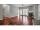 Open-concept living room has hardwood floors, fireplace, and natural light from large windows at 700 Daniel Ellis Dr # 3108, Charleston, SC 29412