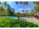 Inviting community pool surrounded by lush vegetation, sun loungers, and relaxation spaces for residents at 700 Daniel Ellis Dr # 3108, Charleston, SC 29412