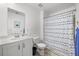 This full bathroom has a white sink vanity, toilet and shower with blue decorative shower curtain at 704 Kilarney Rd, Summerville, SC 29483
