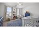 Charming Bedroom with a blue dresser, crib, window seating, and ample natural light at 704 Kilarney Rd, Summerville, SC 29483