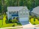 This home has a two-car garage, nice landscaping, and an inviting covered entrance at 704 Kilarney Rd, Summerville, SC 29483