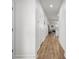 Bright hallway featuring hardwood floors and white walls, leading to the living area and stairs at 704 Kilarney Rd, Summerville, SC 29483