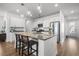 Bright kitchen boasts an island with seating, stainless steel appliances, and wooden floors at 704 Kilarney Rd, Summerville, SC 29483