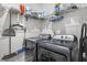 Modern laundry room equipped with a washer, dryer, and wire shelving for storage at 704 Kilarney Rd, Summerville, SC 29483