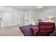 A cozy loft space features a comfortable couch, chair, and an adjoining bedroom at 704 Kilarney Rd, Summerville, SC 29483