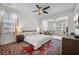 A bright main bedroom boasts a ceiling fan, natural light, sitting area and an elegant rug at 704 Kilarney Rd, Summerville, SC 29483