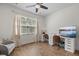 Bright office featuring two desks, modern ceiling fan, large windows, and an accent chair at 704 Kilarney Rd, Summerville, SC 29483