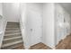 Staircase with carpeted steps, white walls, and a door to storage, offering functional design at 704 Kilarney Rd, Summerville, SC 29483