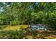 The backyard features a dock, as well as many large trees offering shade for the home at 734 Waterloo St, Charleston, SC 29412