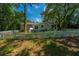 This backyard features a well maintained lawn, as well as a white fence to separate the home from the water at 734 Waterloo St, Charleston, SC 29412