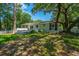 The home's backyard features a deck, screened porch, and views of a mature shade tree, enhancing outdoor living at 734 Waterloo St, Charleston, SC 29412