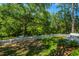 The property features a white picket fence enclosing the backyard, as well as numerous mature trees at 734 Waterloo St, Charleston, SC 29412