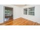 Bright bedroom featuring gleaming hardwood floors, white walls and trim, and natural light from the double windows at 734 Waterloo St, Charleston, SC 29412