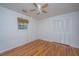 A bright bedroom is filled with hardwood floors, a ceiling fan, and natural light from a window at 734 Waterloo St, Charleston, SC 29412