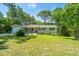 Traditional-style home with a well-maintained lawn, mature trees, and inviting curb appeal in a desirable neighborhood at 734 Waterloo St, Charleston, SC 29412