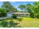 Inviting single-story house with a neat lawn, driveway, and classic design details at 734 Waterloo St, Charleston, SC 29412