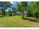 Inviting home with a lush front yard, mature trees, and traditional architecture, showcasing its desirable curb appeal at 734 Waterloo St, Charleston, SC 29412
