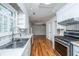 Bright kitchen features white cabinets, a stainless steel oven, and wood floors at 734 Waterloo St, Charleston, SC 29412