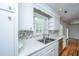 Updated kitchen with white cabinets, tiled backsplash, and modern faucet at 734 Waterloo St, Charleston, SC 29412