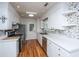 Charming kitchen featuring stainless appliances, tiled backsplash and white cabinets at 734 Waterloo St, Charleston, SC 29412