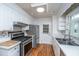 Charming kitchen featuring stainless appliances, tiled backsplash and light cabinets at 734 Waterloo St, Charleston, SC 29412