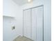 Simple laundry room with bi-fold doors and an upper shelf for storage at 734 Waterloo St, Charleston, SC 29412