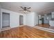 Open living room featuring hardwood floors, ceiling fan, and seamless transition to kitchen at 734 Waterloo St, Charleston, SC 29412