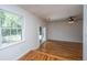 Bright living room with hardwood flooring, sliding glass door, and large window overlooking backyard at 734 Waterloo St, Charleston, SC 29412