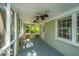Relaxing screened porch with a grey brick wall, ceiling fans, and a view of the lush greenery at 734 Waterloo St, Charleston, SC 29412