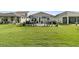 Beautifully landscaped backyard features patio with seating and lush green lawn perfect for outdoor enjoyment at 753 Blue Iris Way, Summerville, SC 29486
