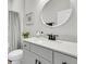Well-lit bathroom features a decorative mirror, white vanity with ample storage, and modern black fixtures at 753 Blue Iris Way, Summerville, SC 29486