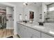 Stylish bathroom with a double vanity, granite counters, and walk-in closet access, providing convenience at 753 Blue Iris Way, Summerville, SC 29486