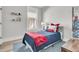 Cozy bedroom featuring a twin bed with stylish red, white, and blue accents, enhanced by natural light from the window at 753 Blue Iris Way, Summerville, SC 29486
