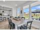 Light-filled dining area boasts large windows with views of green space and access to the modern kitchen at 753 Blue Iris Way, Summerville, SC 29486