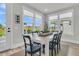 Bright dining room features large windows with backyard views and an inviting atmosphere at 753 Blue Iris Way, Summerville, SC 29486