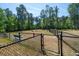 The community dog park is fenced with a bench for dog owners to relax at 753 Blue Iris Way, Summerville, SC 29486