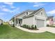Home featuring light gray siding, a two-car garage, and well-manicured landscaping at 753 Blue Iris Way, Summerville, SC 29486