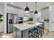 Modern kitchen with stainless steel appliances and a large center island at 753 Blue Iris Way, Summerville, SC 29486