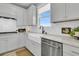 Bright kitchen features white cabinets, stainless steel appliances, subway tile backsplash and black faucet at 753 Blue Iris Way, Summerville, SC 29486