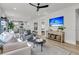 Open-concept living room with modern decor, hardwood flooring and backyard view at 753 Blue Iris Way, Summerville, SC 29486