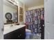 Well-maintained bathroom with a vanity, decorative mirror, and tiled floors at 8059 Shadow Oak Dr, North Charleston, SC 29406