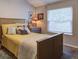 Comfortable bedroom showcasing a queen-size bed, neutral tones, and natural light from a window at 8059 Shadow Oak Dr, North Charleston, SC 29406