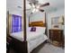 Cozy bedroom with a four poster bed, side table, and a large window for natural light at 8059 Shadow Oak Dr, North Charleston, SC 29406