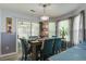 Bright dining space featuring a table for six, chandelier, and natural light from sliding glass doors at 8059 Shadow Oak Dr, North Charleston, SC 29406