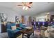 Inviting living room featuring comfortable seating, a ceiling fan, and an adjacent wet bar at 8059 Shadow Oak Dr, North Charleston, SC 29406