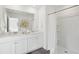 Bright bathroom featuring a double sink vanity with white cabinets, quartz countertop, and neutral decor at 8712 Silver Perch Ln, North Charleston, SC 29420