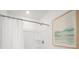 Bright, clean bathroom featuring a shower/bath with white curtain and modern art at 8712 Silver Perch Ln, North Charleston, SC 29420